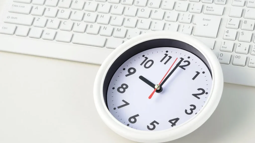 White clock on a white keyboard - concept of saving time with digital signature